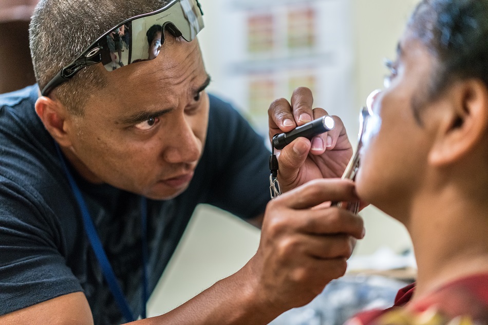 Padwick Gallen, MD, examining a patient in Micronesia.