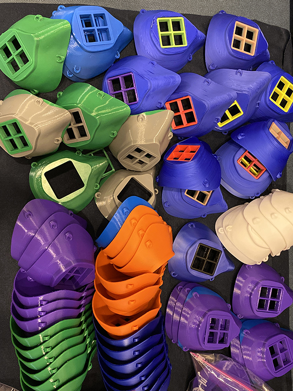 The 3D-printed masks stand ready to be fitted with liners, elastics, and filters.