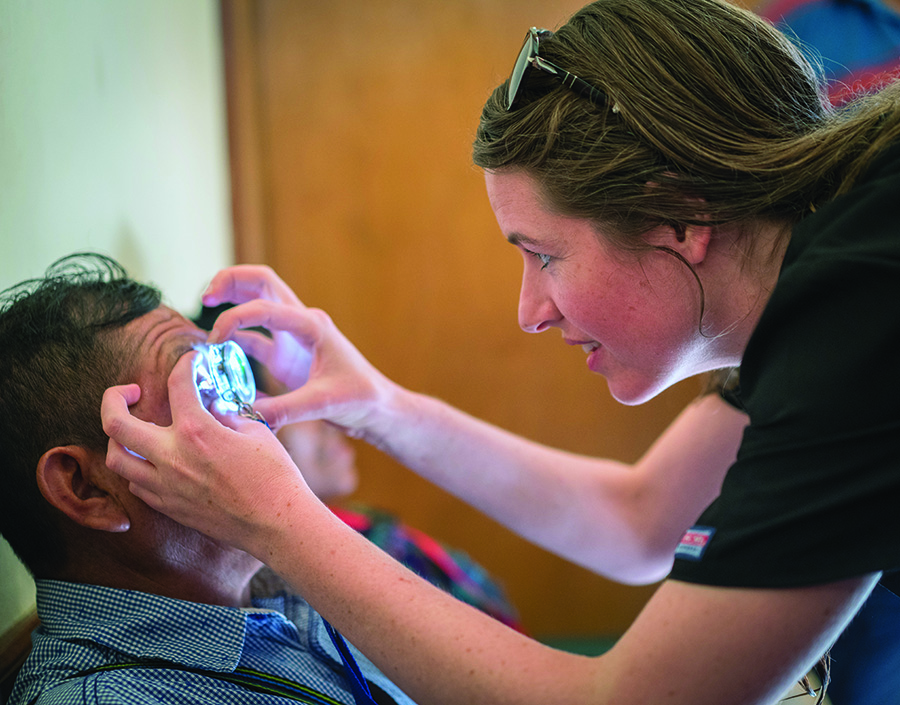 Ashlie Bernhisel, MD, Moran’s current global fellow, performs outreach care during a pre-2020 international trip.