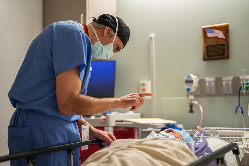 Nick Mamalis, MD, examines a patient following cataract surgery at a recent Operation Sight Day, an annual charitable surgery event at the Moran Eye Center funded by donors.
