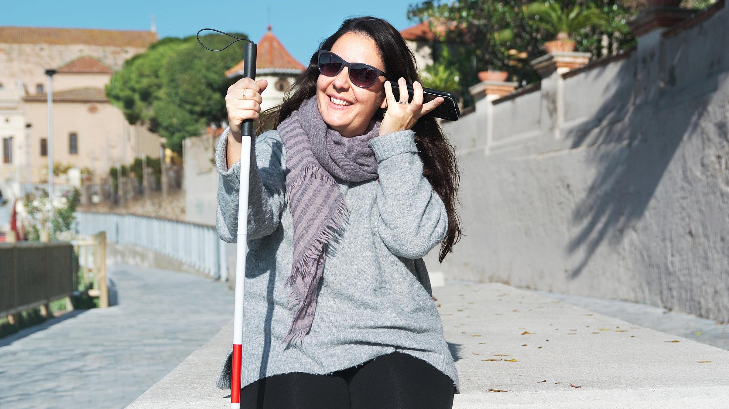 Woman with visual impairment talking on a cell phone.