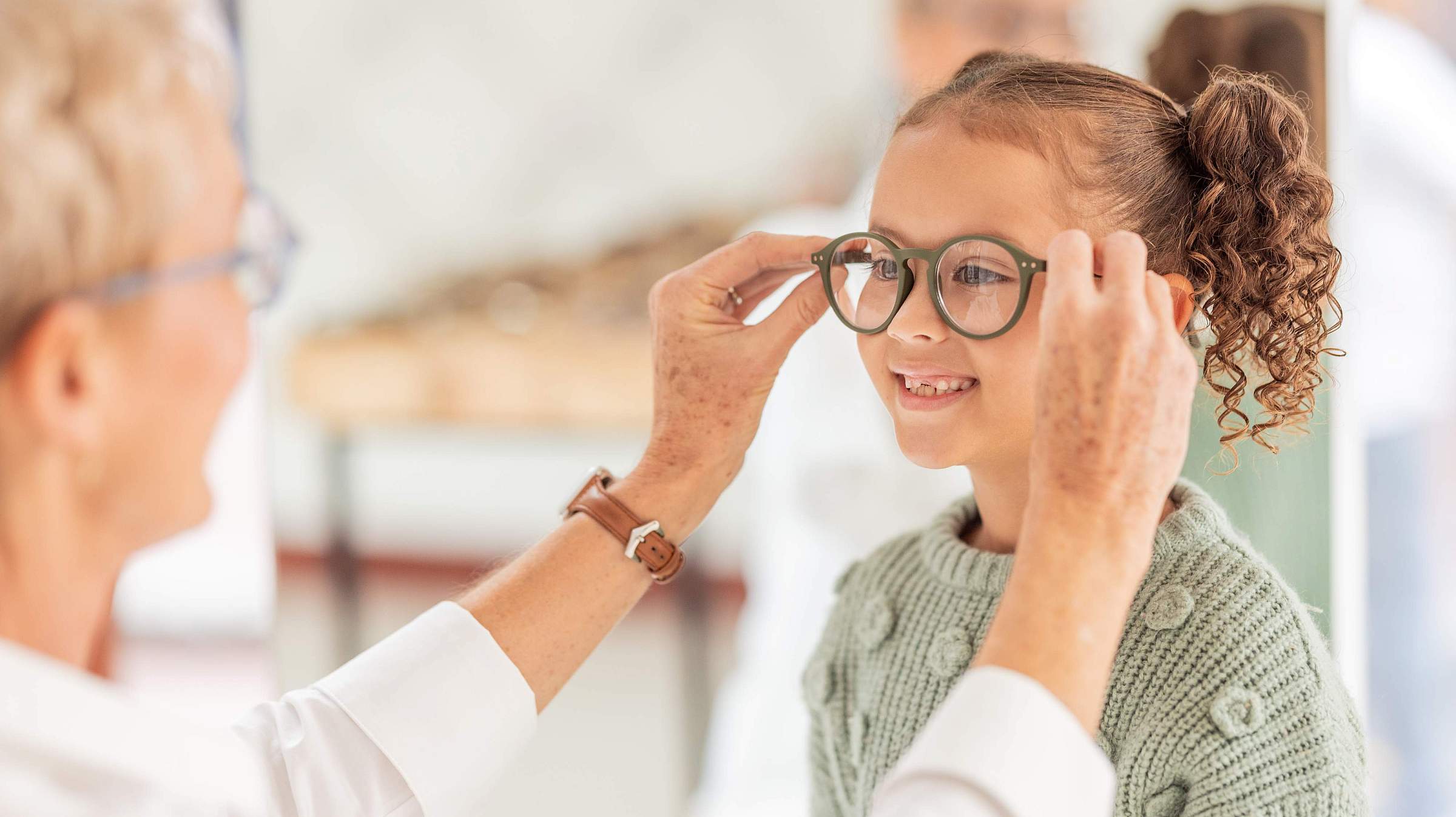 Child being fitted for eyeglasses
