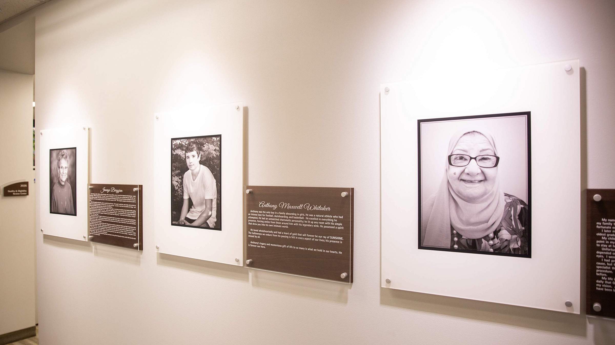 Three donor stories featured on a wall at the Utah Lions Eye Bank