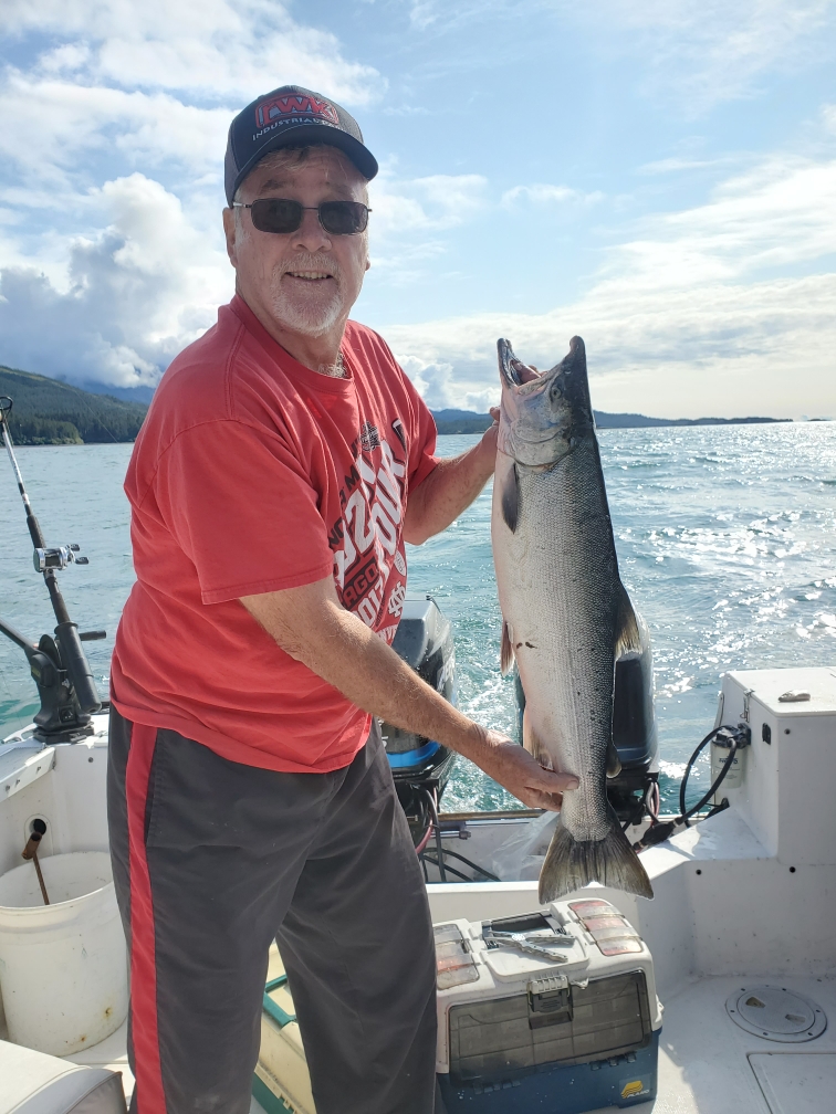 Gary Jones in a boat holding a large fish