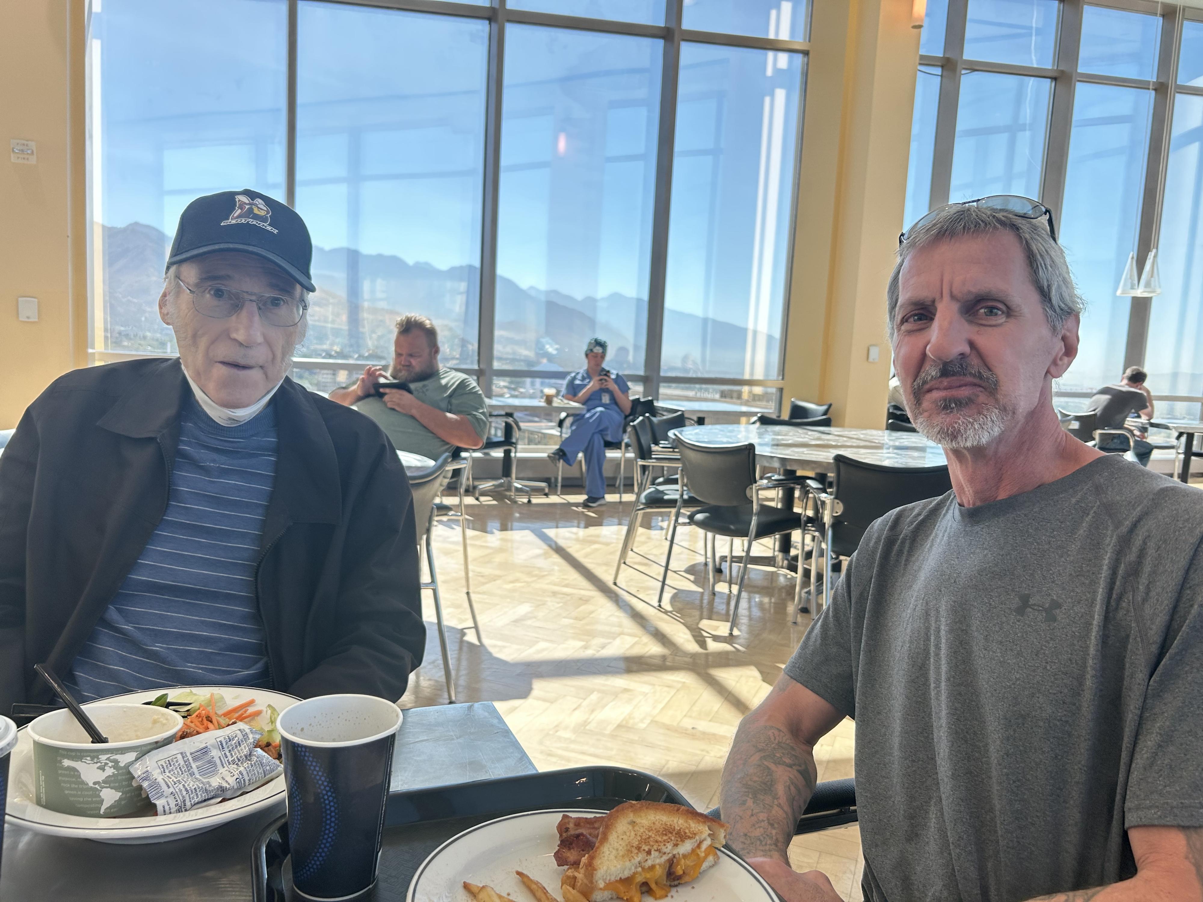 Two men eating lunch together