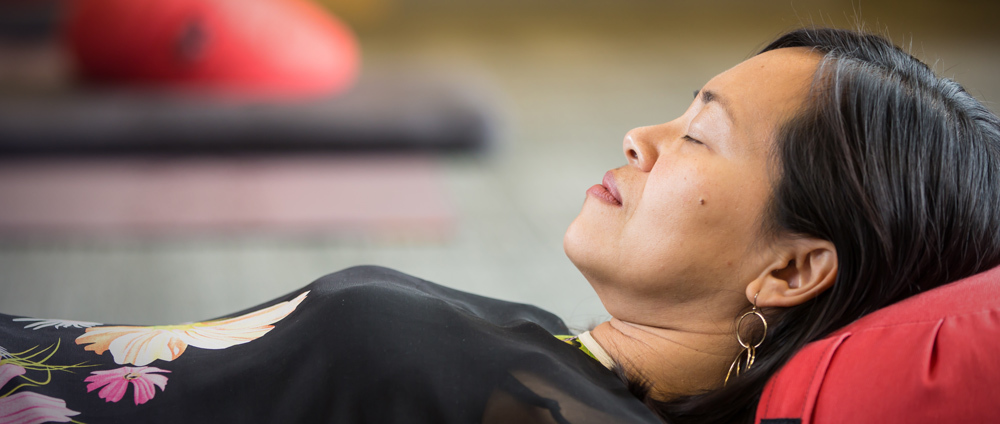 A person laying down practicing mindfulness body scan.