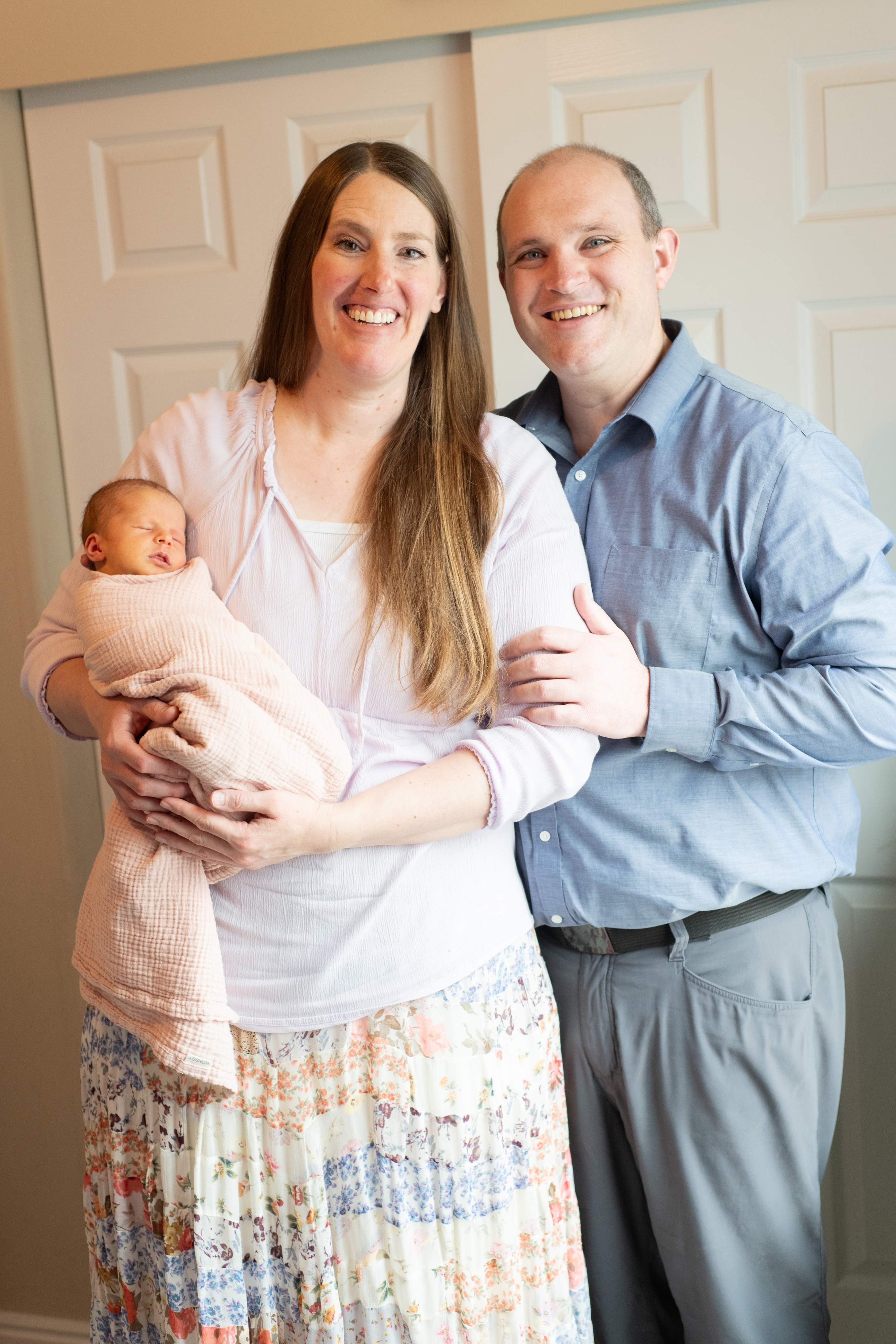 Kirsten Adams with husband and new baby