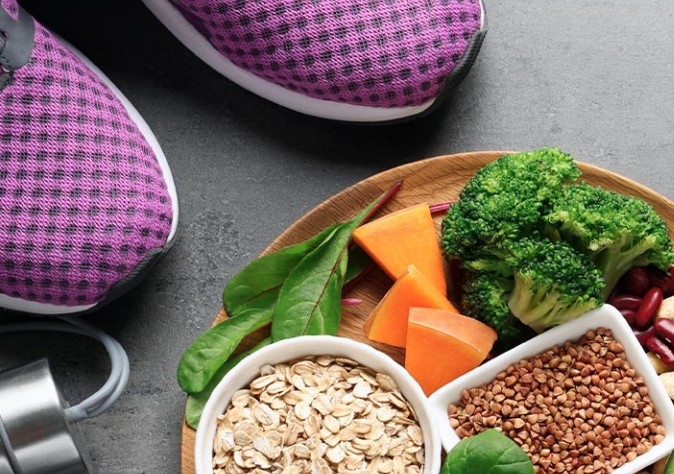 Someone standing next to a plate full of healthy food