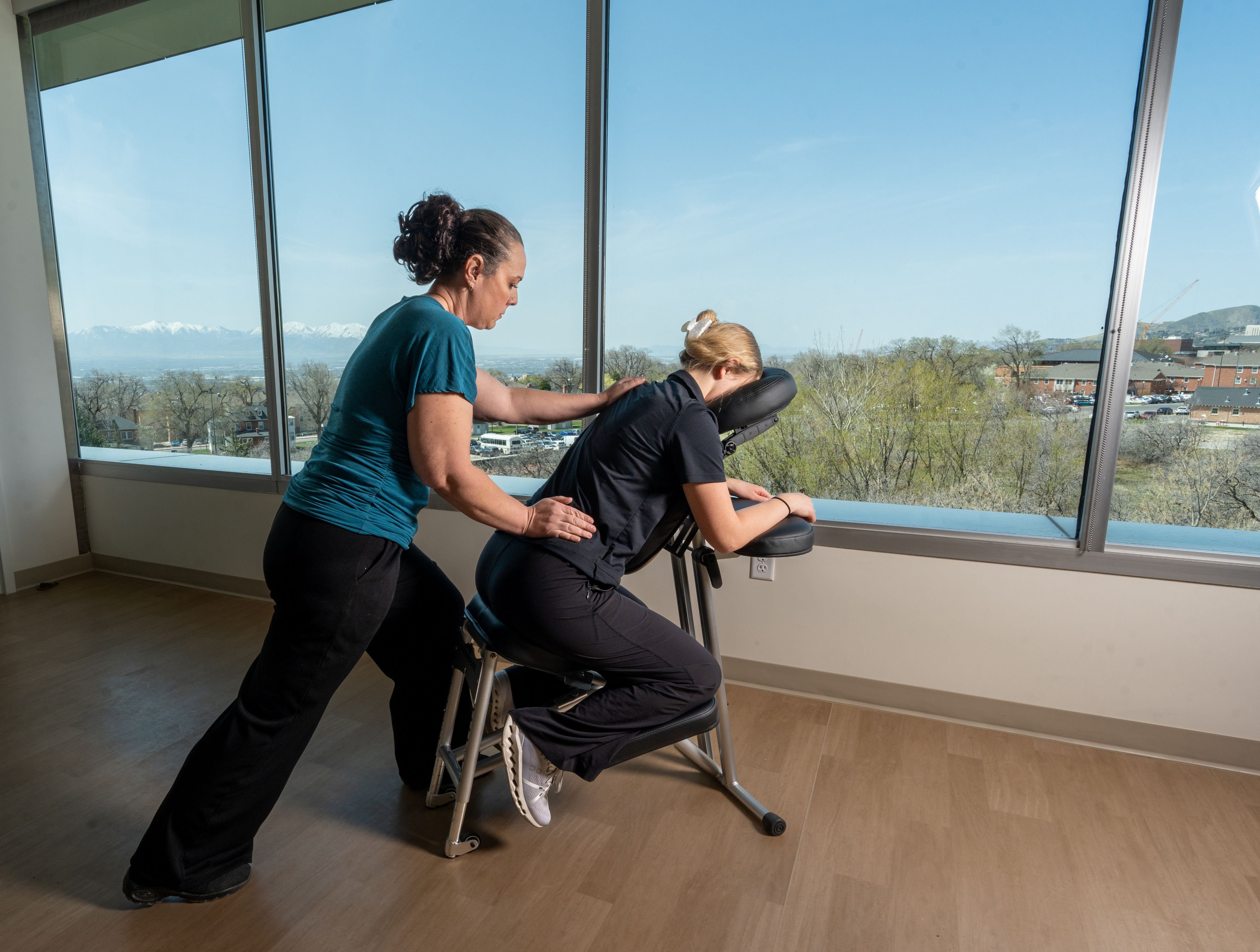 Massage Therapist, Teri Josephson, gives a chair massage with a view