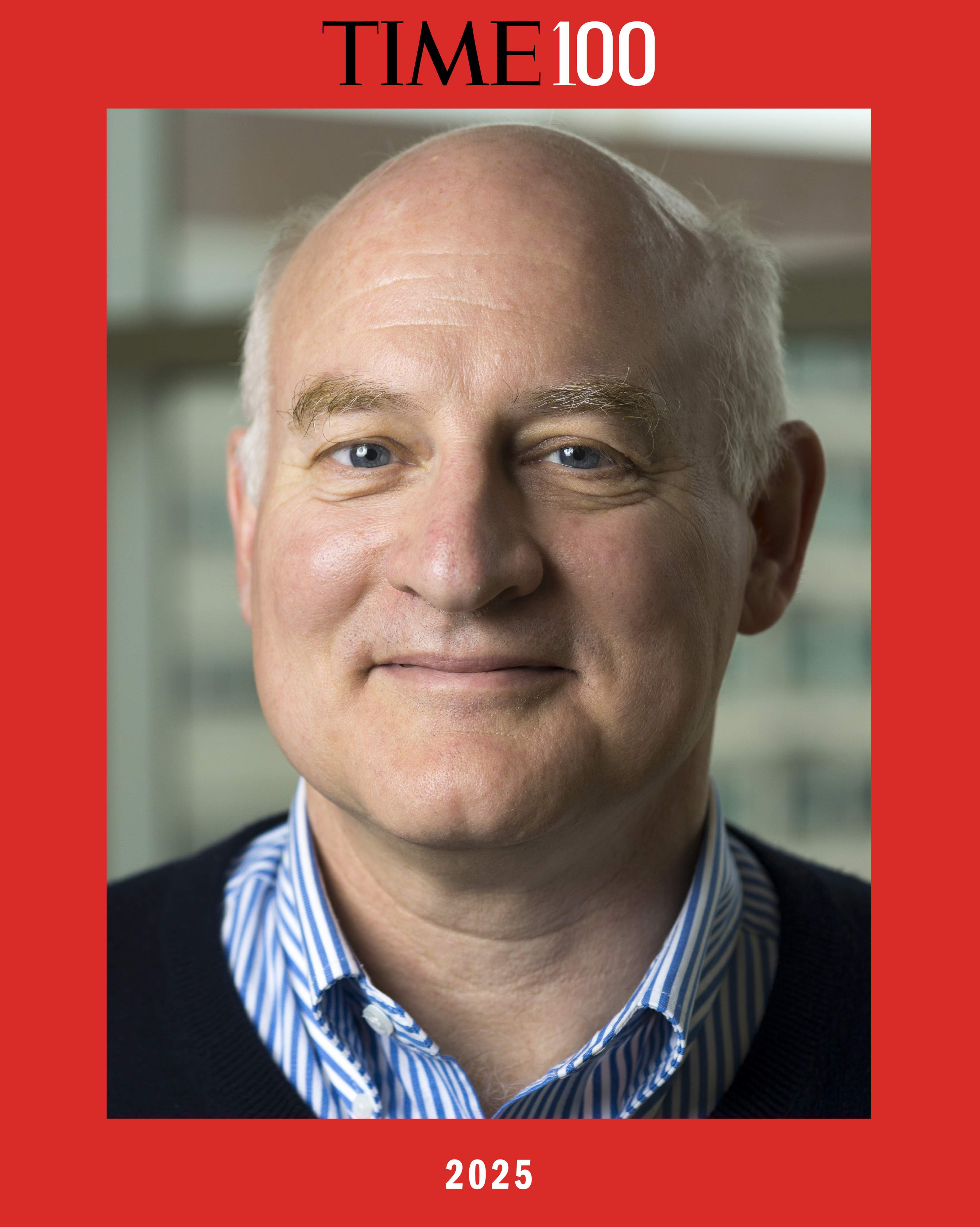 A person in a collared shirt and sweater smiles at the camera, surrounded by a bold red frame that contains the text: TIME100 2025.