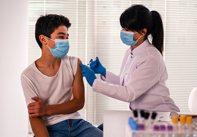 nurse giving man covid-19 vaccine