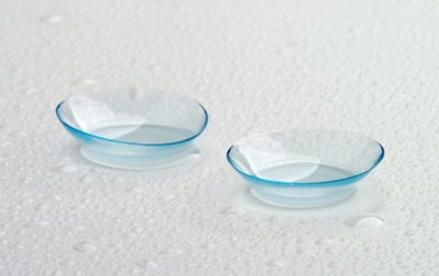 Two contact lenses on a white surface