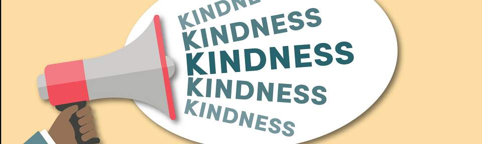 A person holding a megaphone shouting "Kindness"