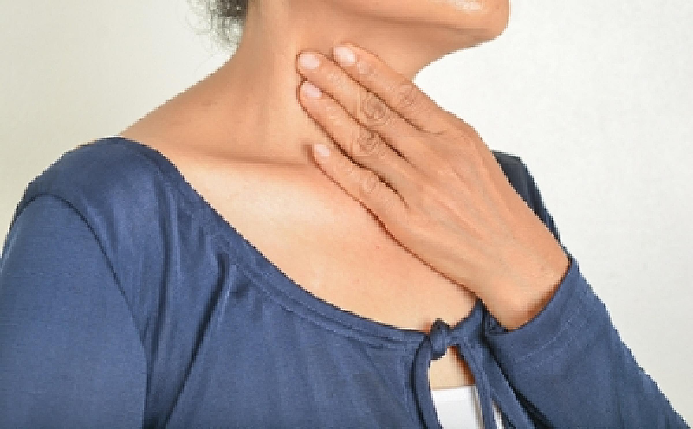 Woman with hand on neck