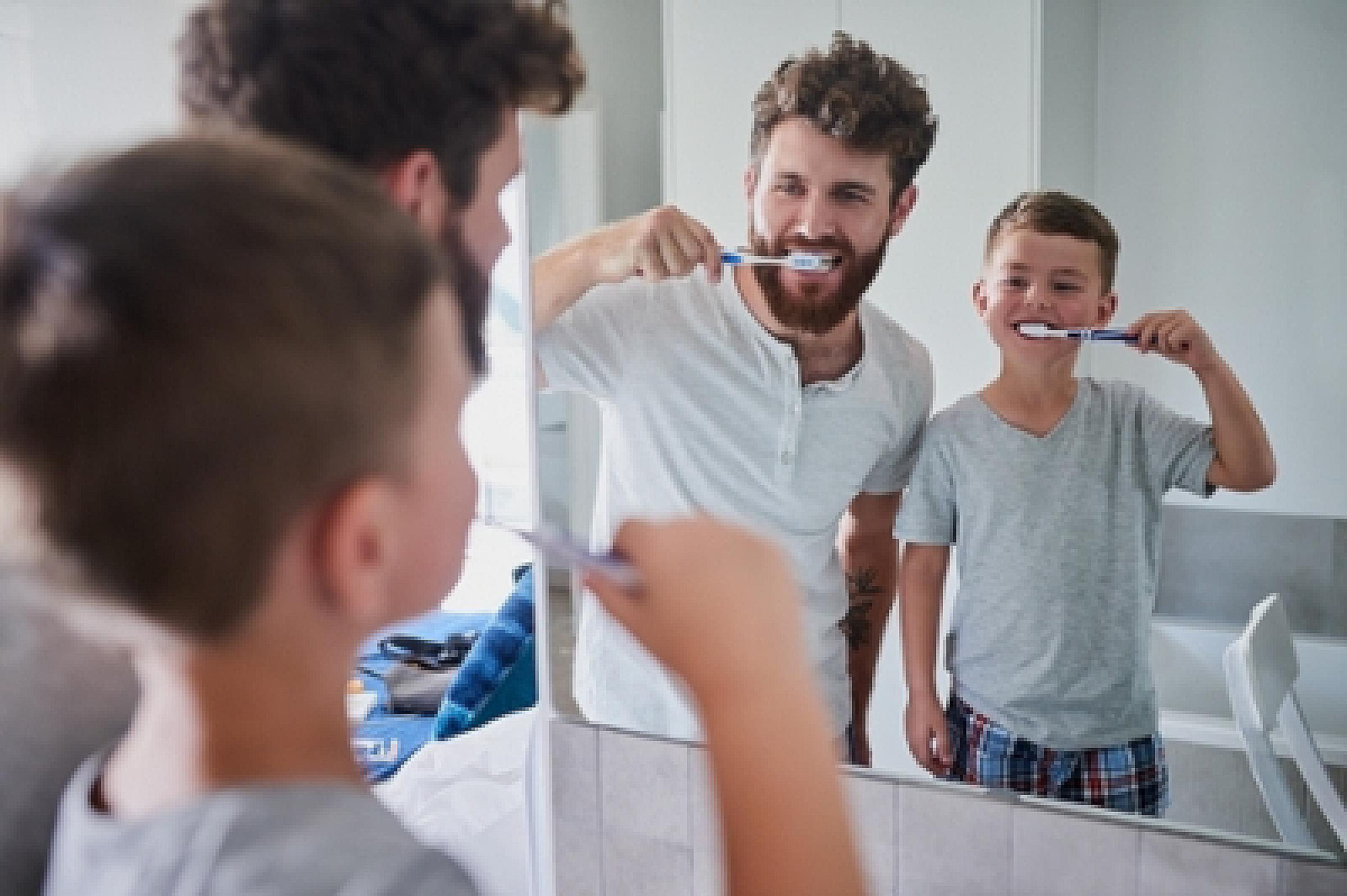 Father and son brushing teeth