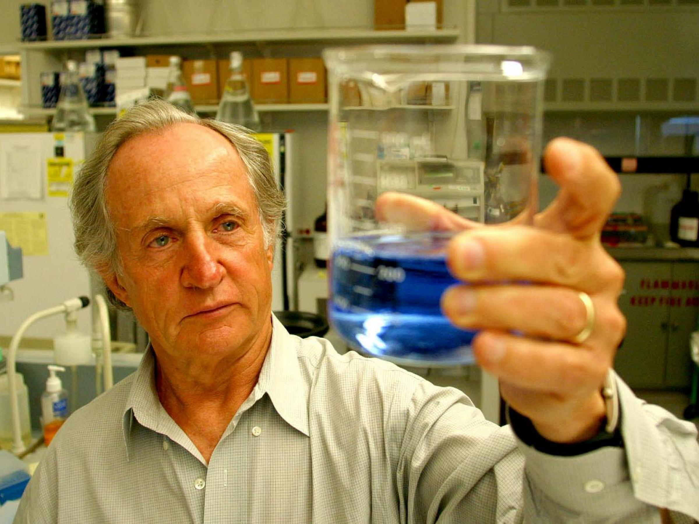 Mario Capecchi with beaker