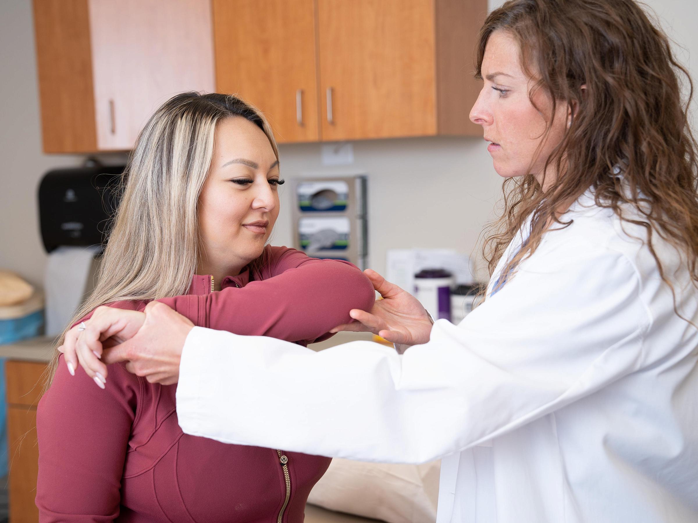 Patient wearing a red jacket with U of U Health orthopedic provider