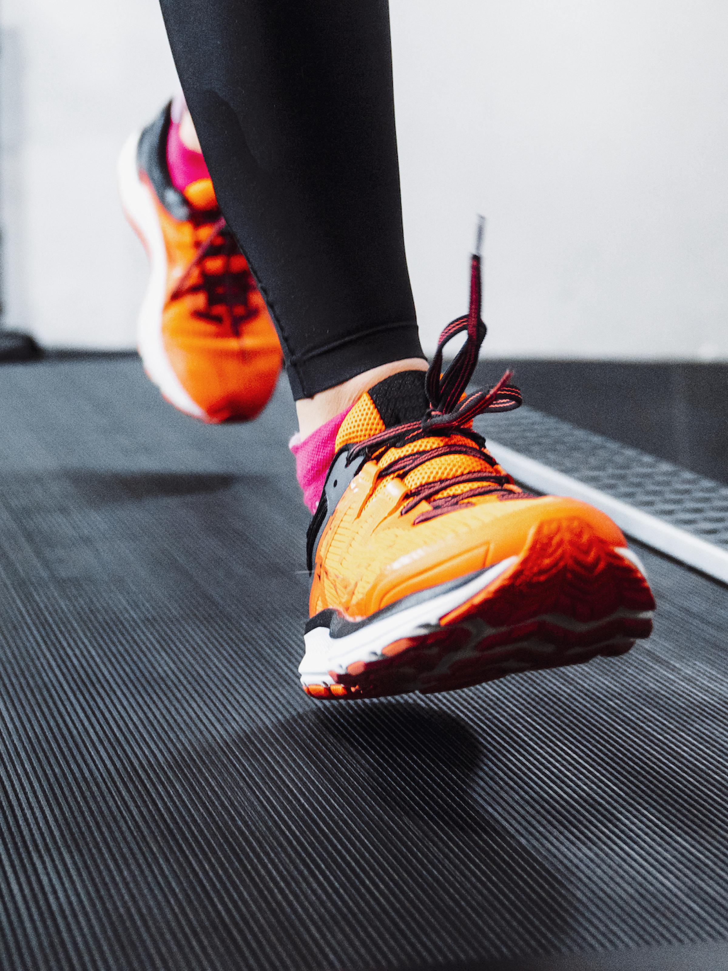 Lower legs and shoes running on a treadmill