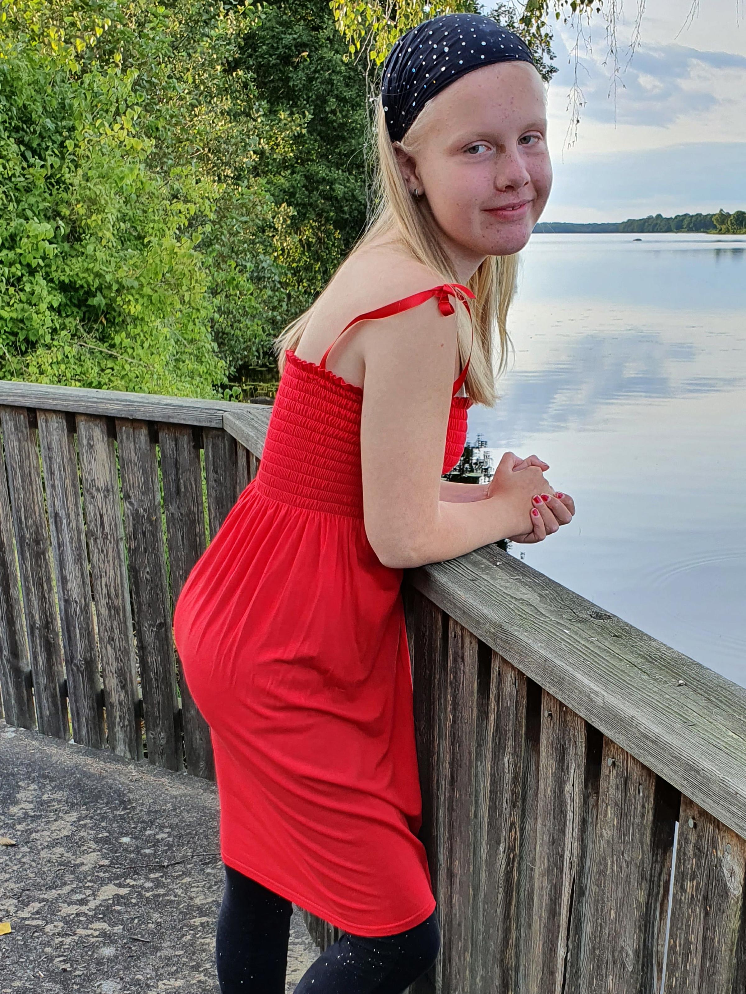 Edith Molsted, epilepsy patient, standing on a wooden deck overseeing water