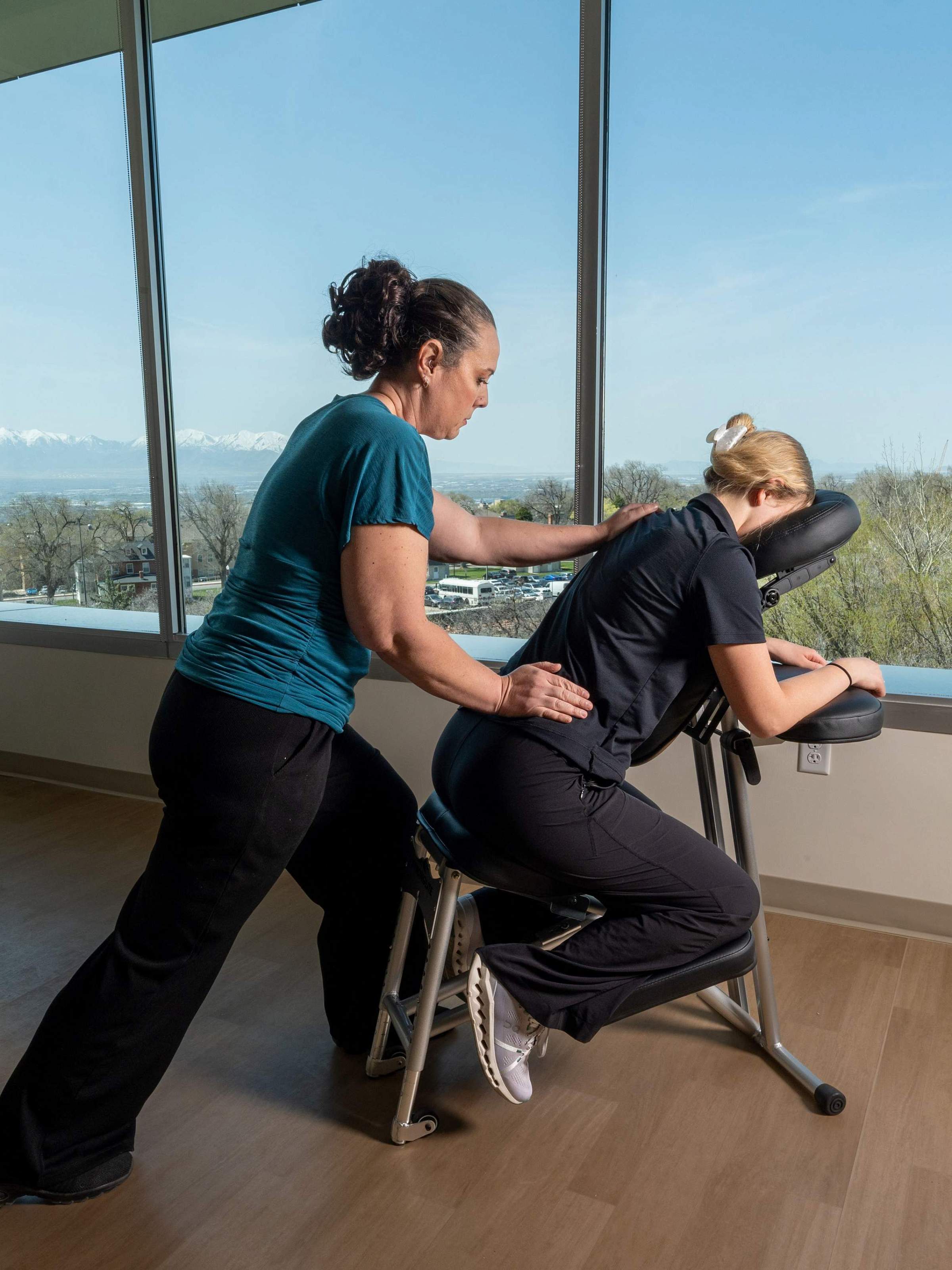 Member of U of U Health Massage Team Doing a Chair Massage
