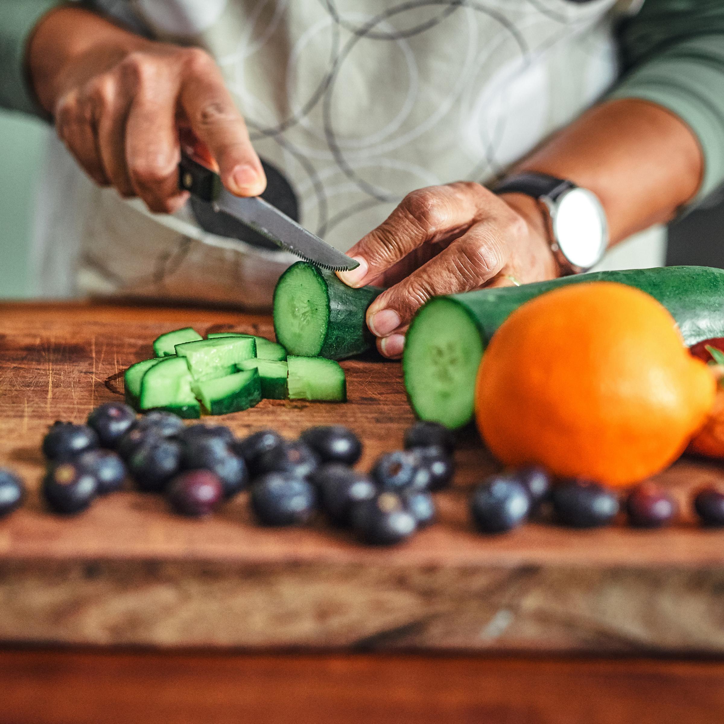 Person cutting up vegetables on a cutting board