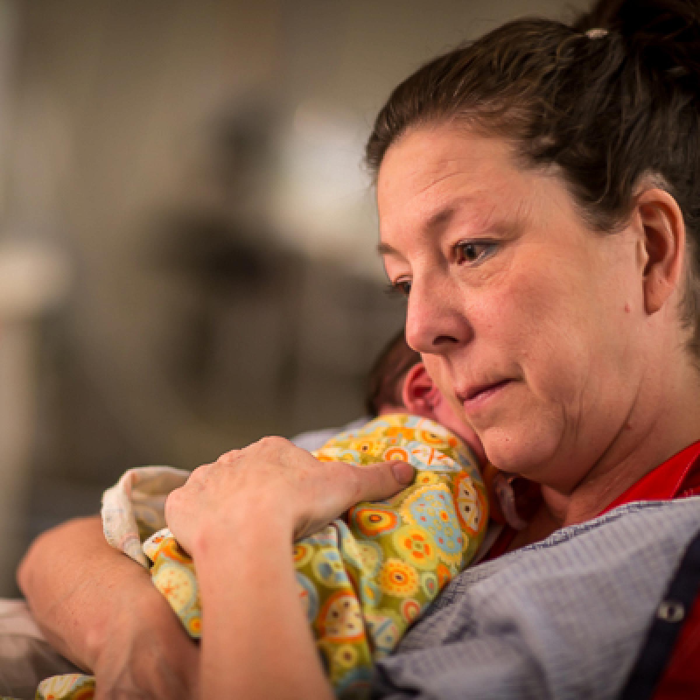 Cuddler at University of Utah Hospital holding a NICU preemie