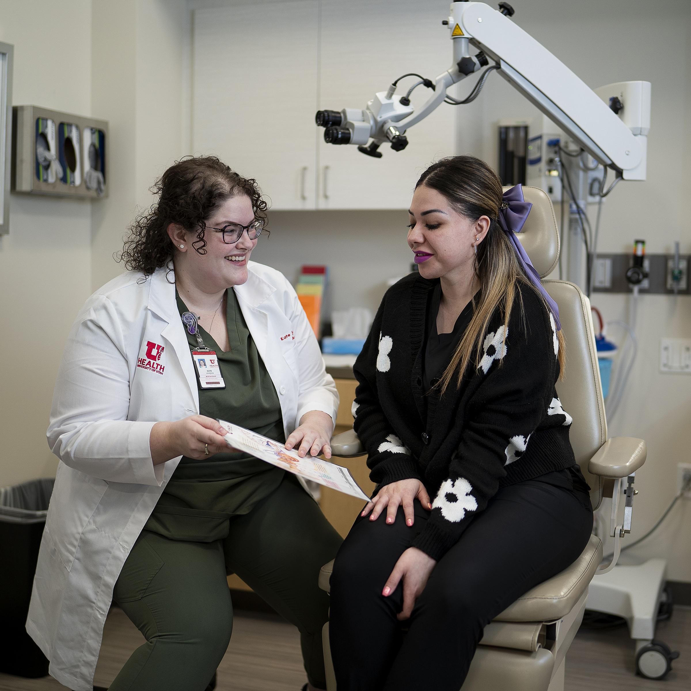 Kate Johnson, AUD, CCC-A, with patient 