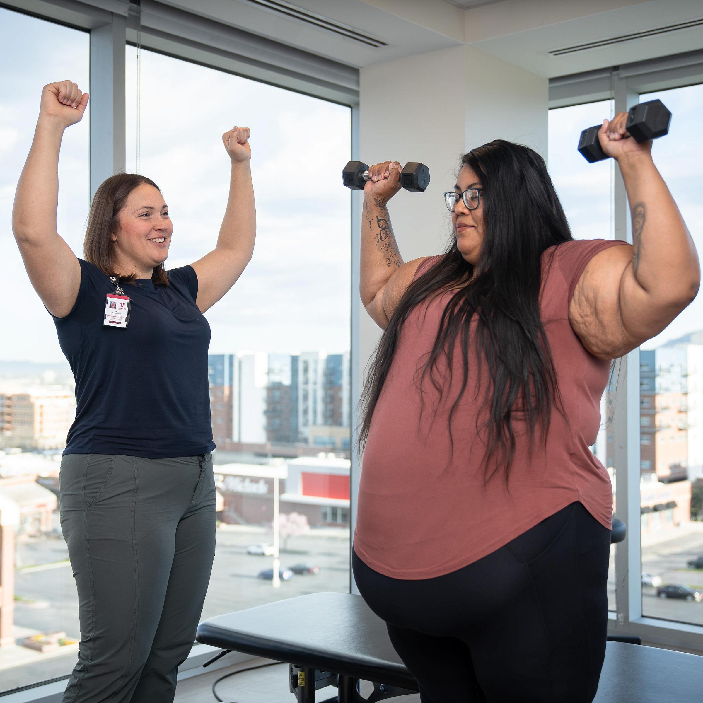 U of U Health specialist teaches arm exercises to a weight management patient