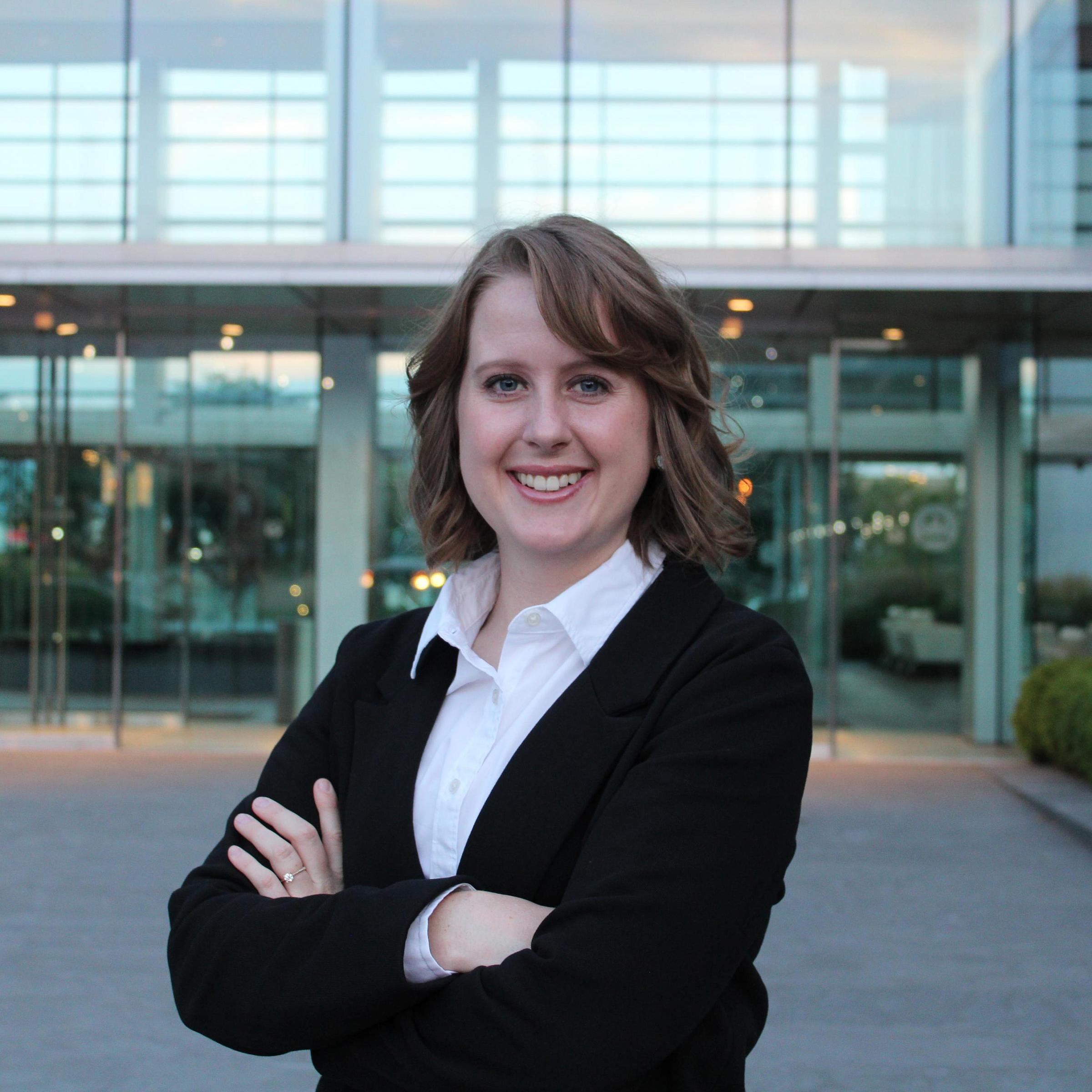 Miquelle Leslie-Cheng stands outside of glass doors of U of U Health campus.