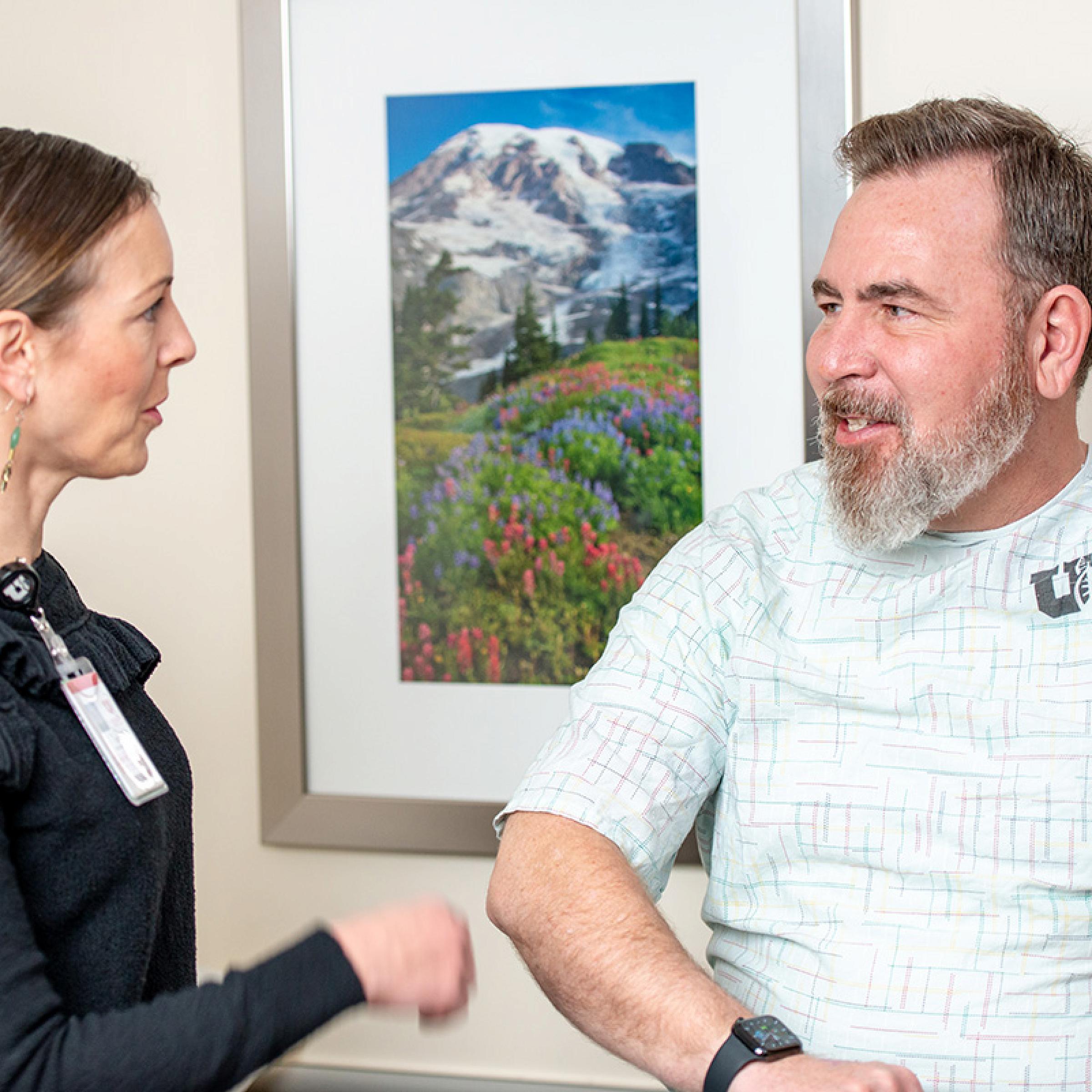 U of U Health provider examining a patient's arm at the Orthopedic Injury Clinic