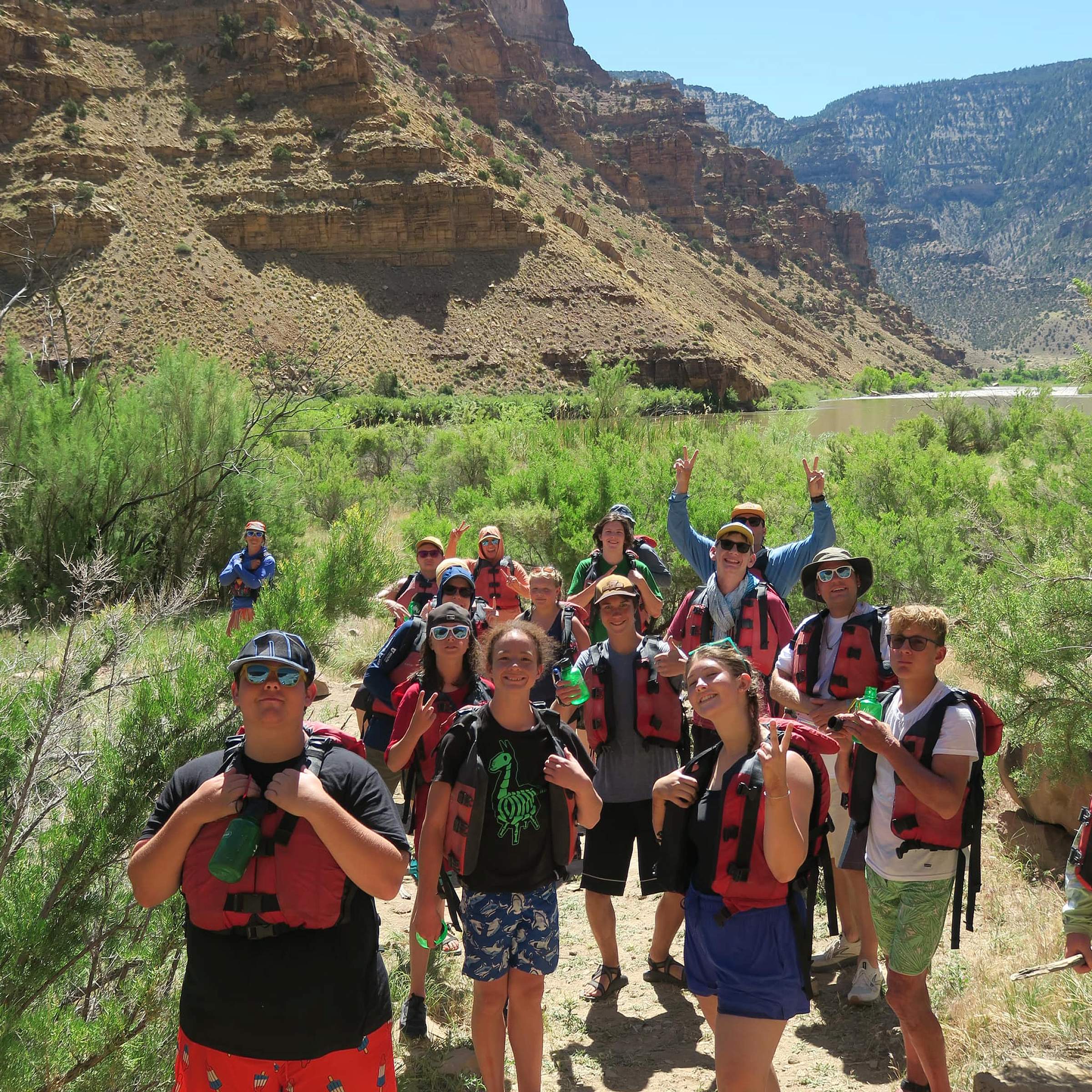 Teen burn camp attendees in a desert wash