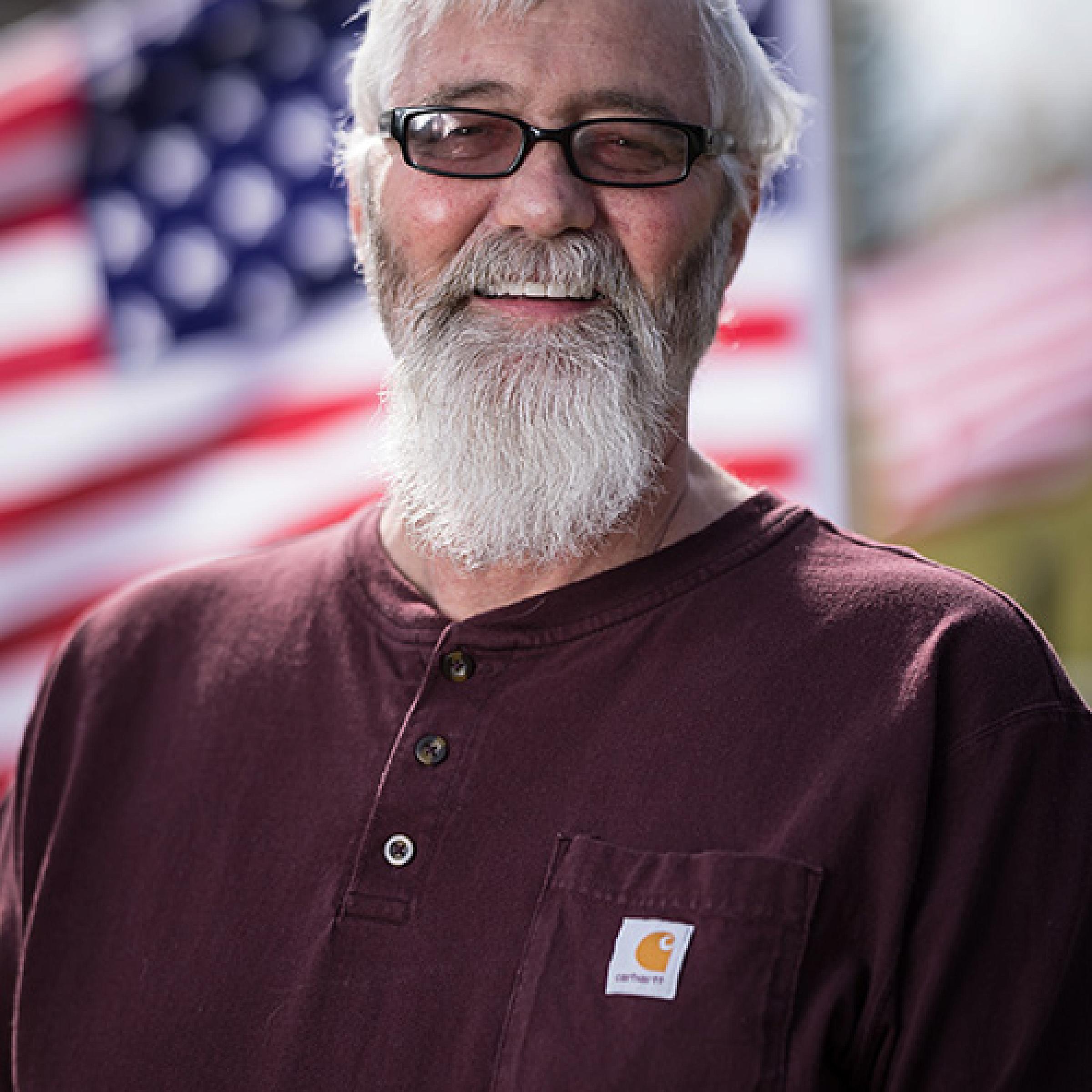 Joe Rands, lung transplant patient in front of an American flag