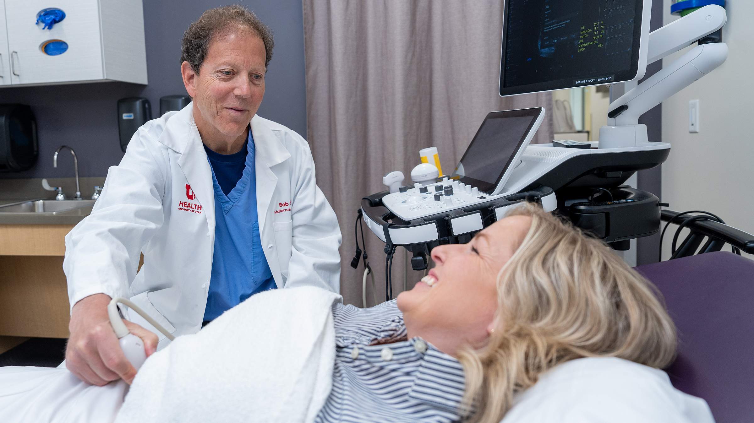U of U Health provider performs ultrasound on pregnant female patient