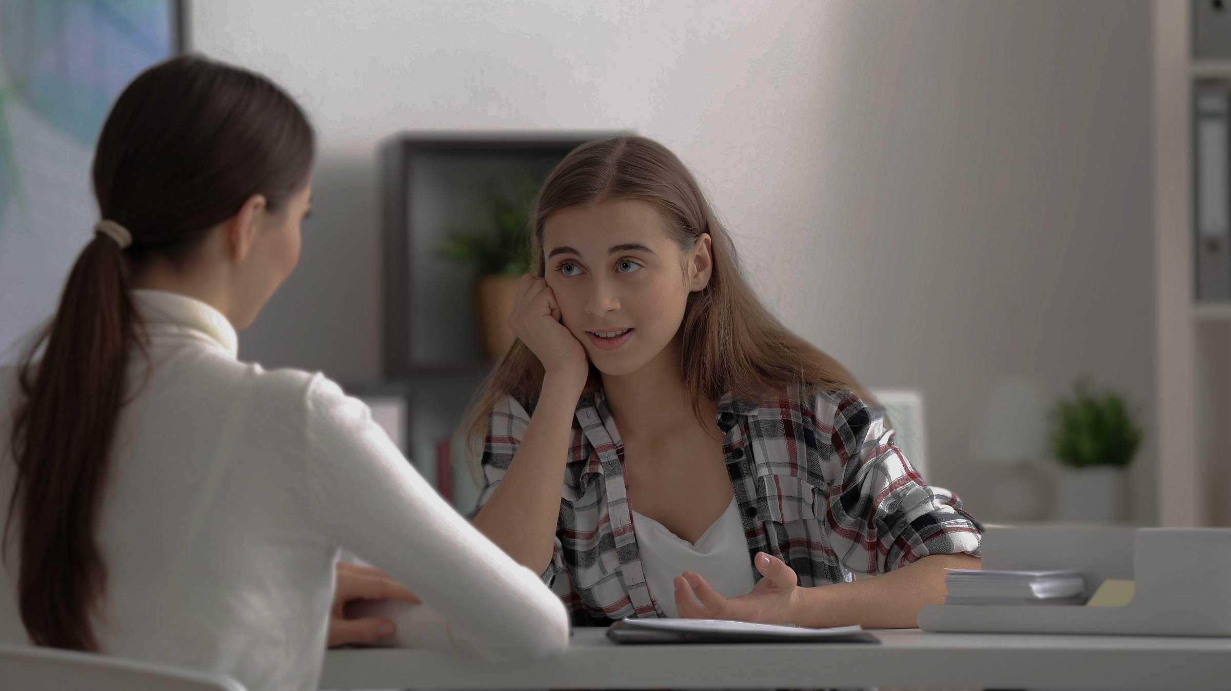 Young teen girl talking to a doctor